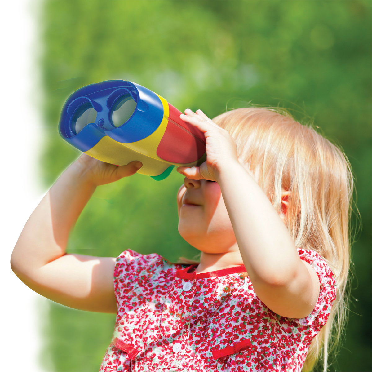 Little girl looking through binoculars outdoor